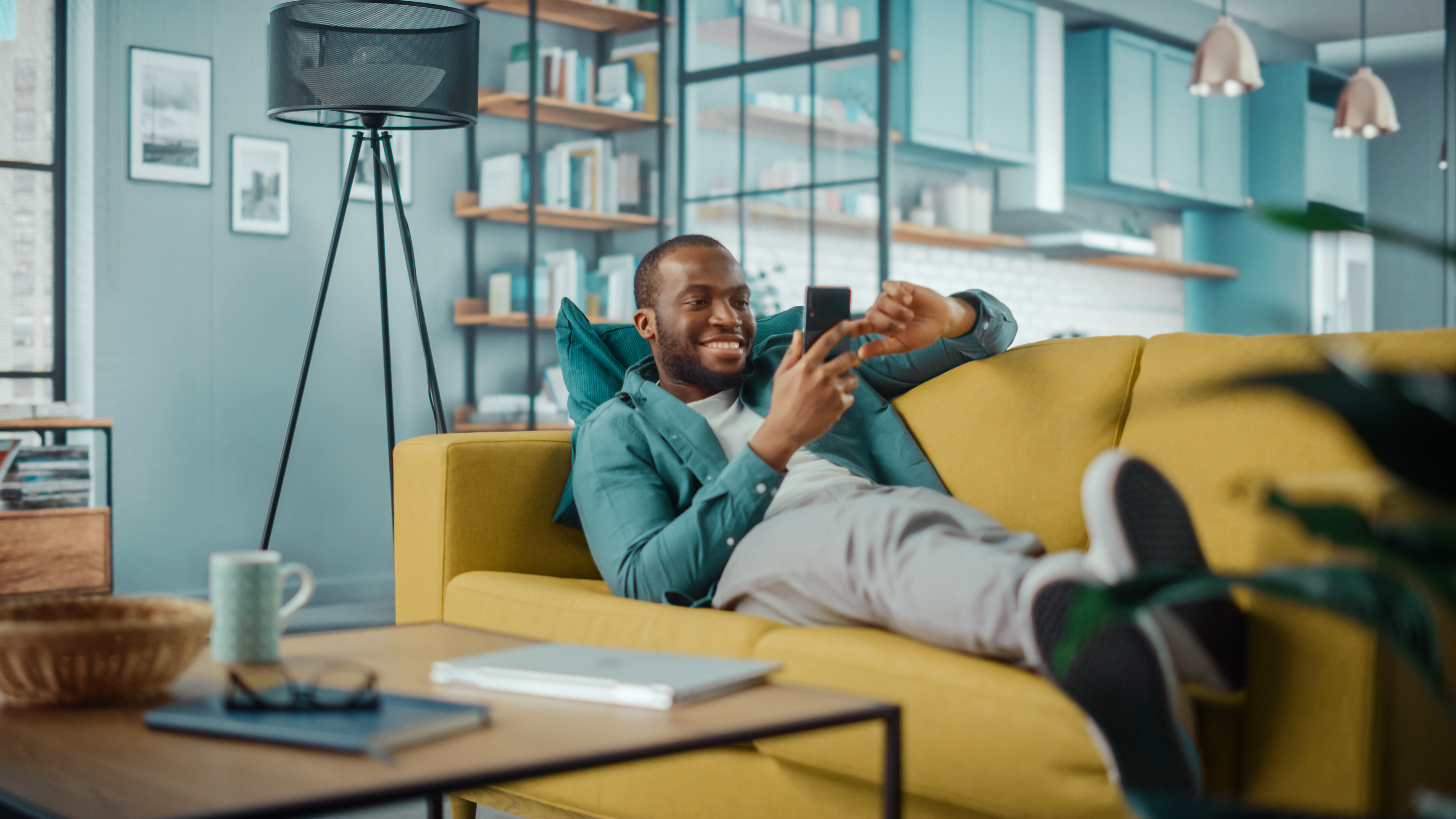 Person sitting on couch working on laptop